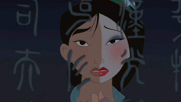 A still image from Disney's Mulan. Mulan is looking at her reflection which is cut in half--one side of her face has makeup and the other does not.